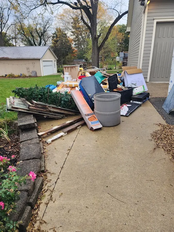 Dumpster being loaded with debris for Estate Cleanout Dumpster Rental in Grove City